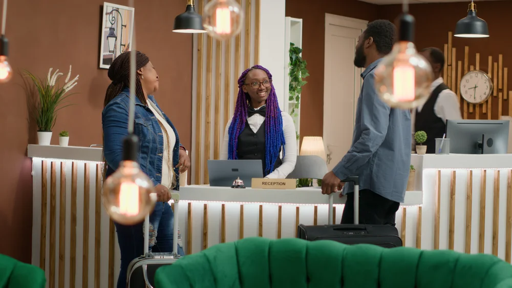 Guests interacting with a hotel employee